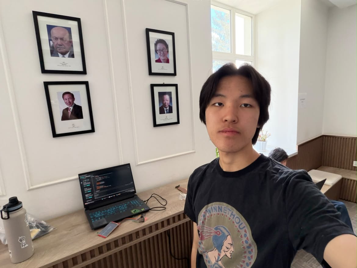 Itgel next to a laptop with code on the screen